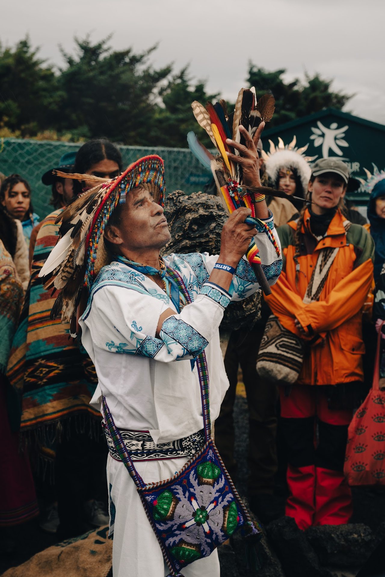 Elder leading a feather blessing at Iceland Eclipse 2026